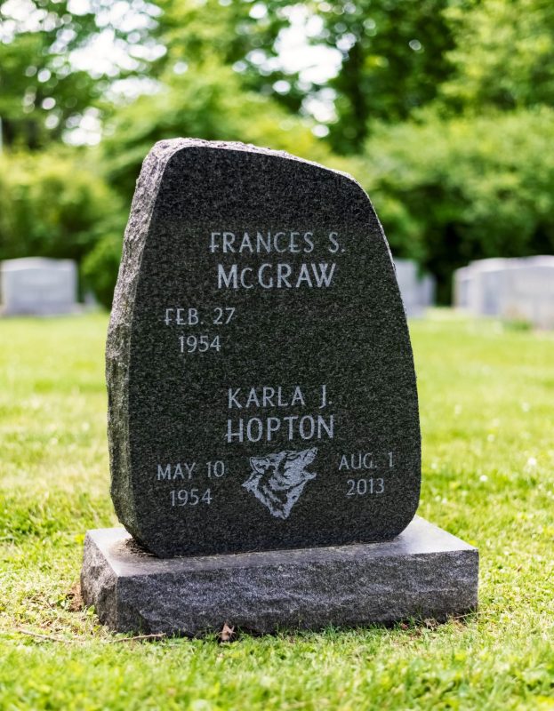 McGraw Memorial with Howling Wolf Carving on Brown Granite